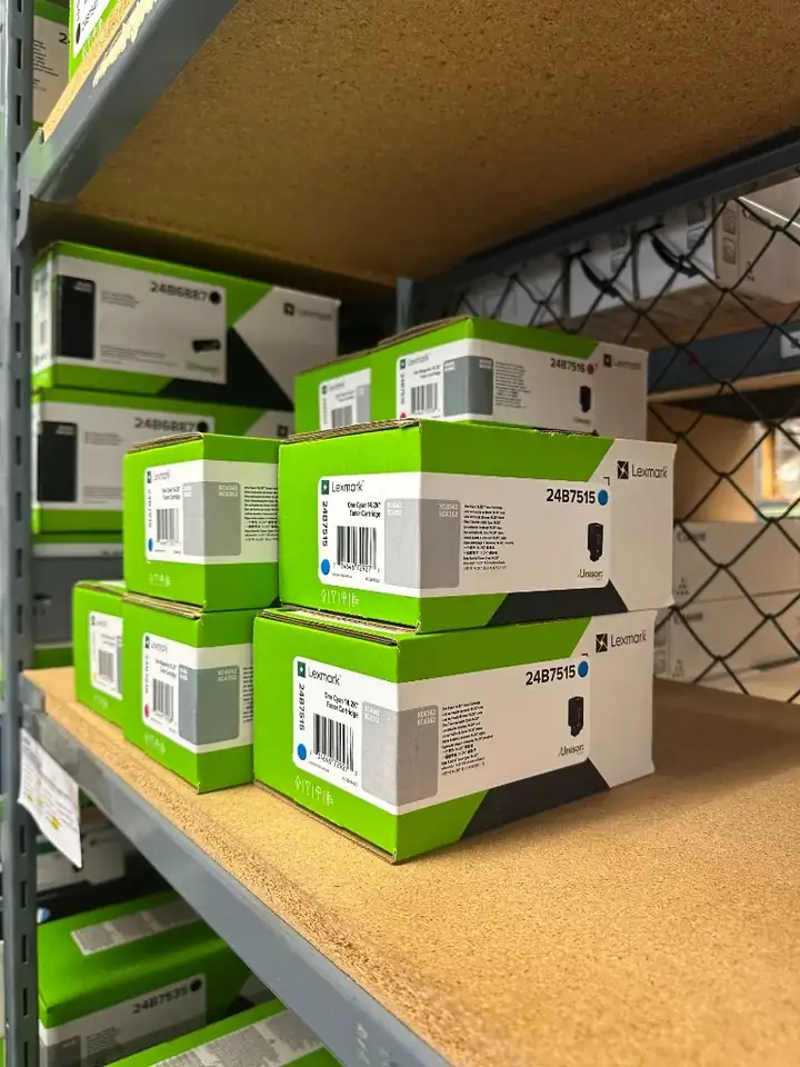Lexmark toner cartridges stored on a shelf
